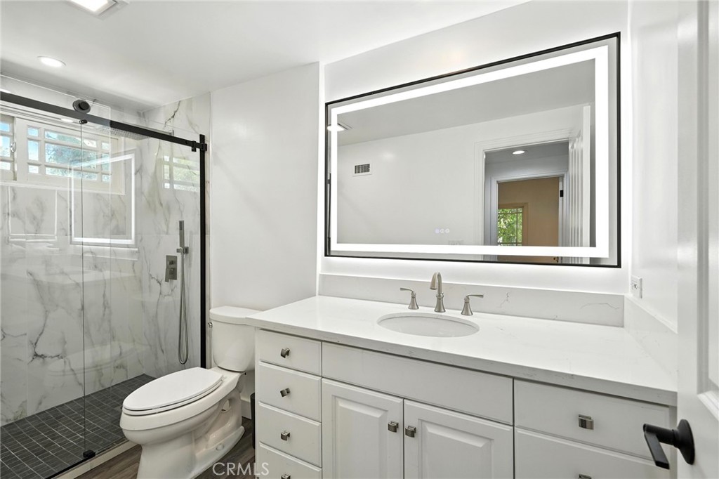 4141 Coldstream Terrace Tarzana, CA 91356 - Photo 29 of 41 a bathroom with a sink toilet and shower