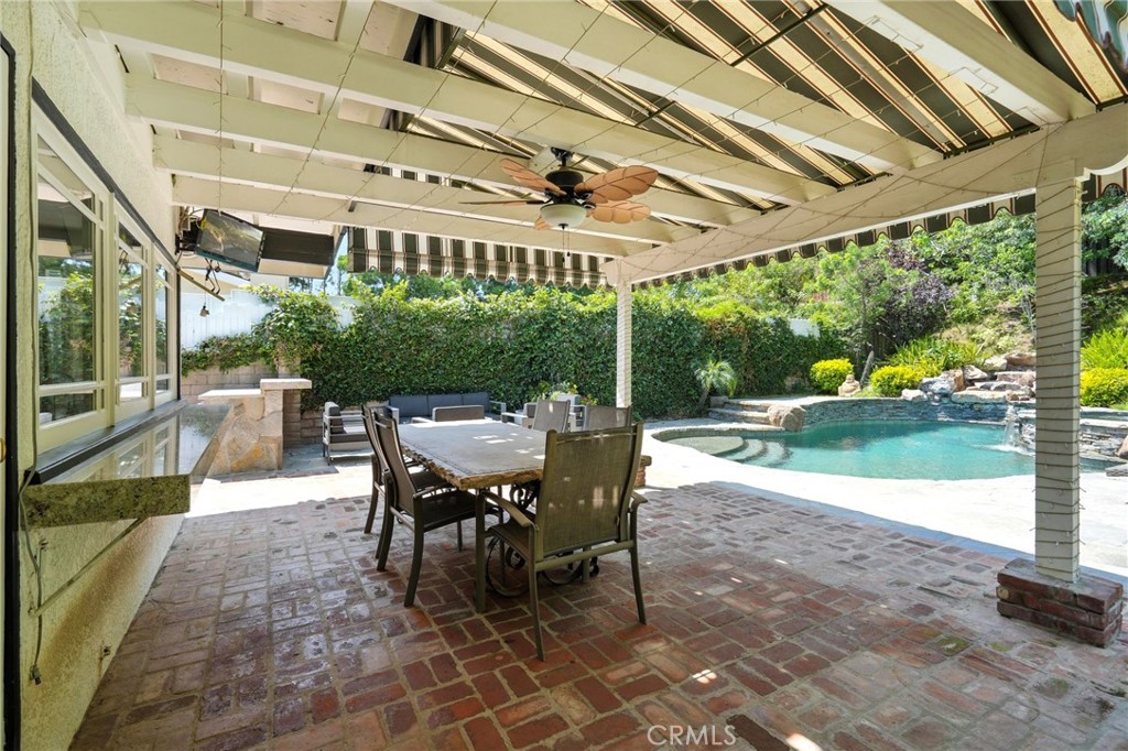 4141 Coldstream Terrace Tarzana, CA 91356 - Photo 33 of 41 a view of a patio with a table chairs and a backyard
