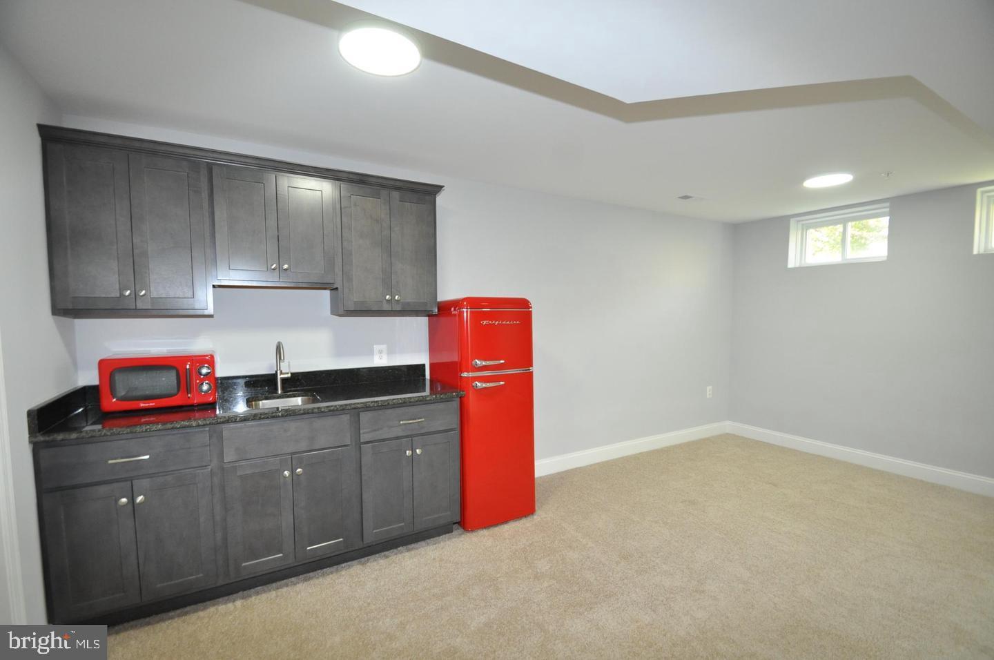 9507 Garwood Street Silver Spring, MD 20901 - Photo 22 of 25 WET BAR HAS MICROWAVE AND REFRIGERATOR