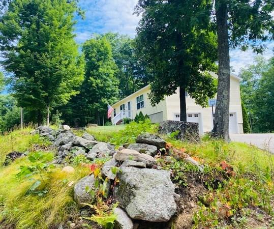 499 Beaman Road Warren, MA 01083 - Photo 1 of 40 a view of a garden with plants and large trees