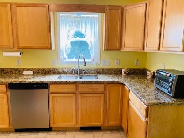 499 Beaman Road Warren, MA 01083 - Photo 13 of 40 a kitchen with granite countertop a sink dishwasher stove and cabinets