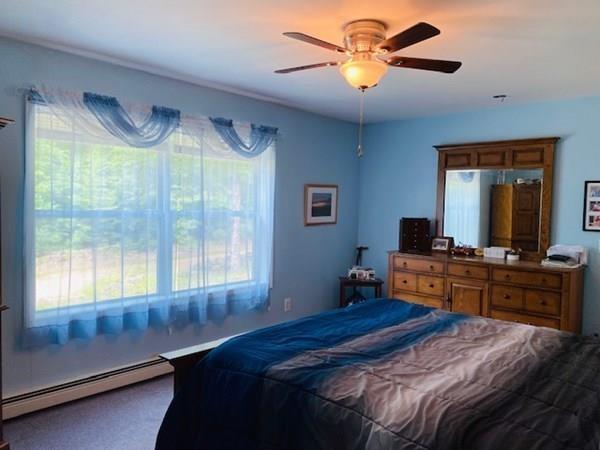 499 Beaman Road Warren, MA 01083 - Photo 14 of 40 a bedroom with a large bed and a chandelier
