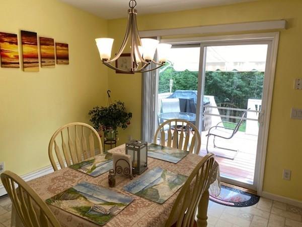 499 Beaman Road Warren, MA 01083 - Photo 9 of 40 a dining room with furniture a chandelier and wooden floor