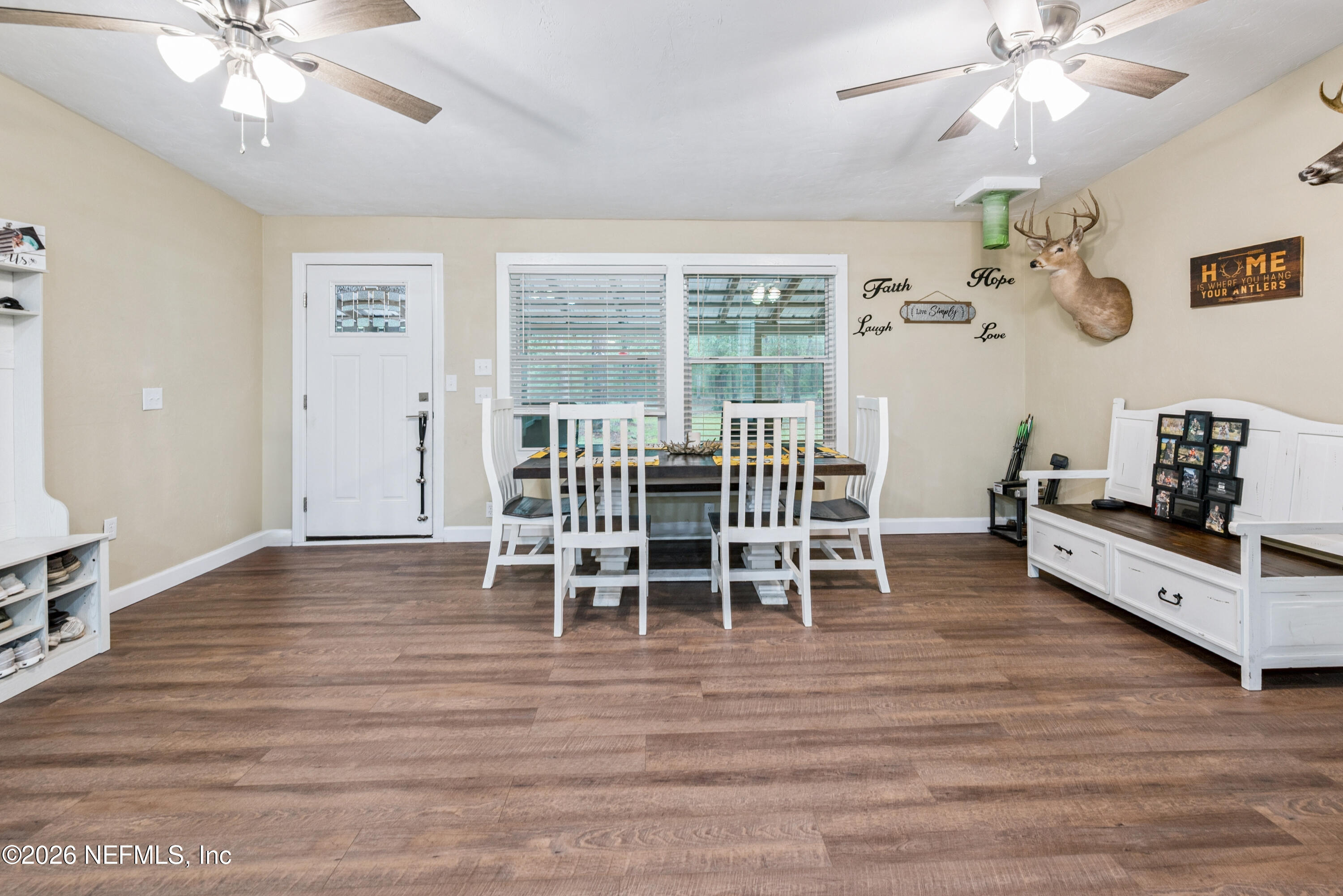 11309 Southwest 167th Circle Brooker, FL 32622 - Photo 12 of 42 a view of a dining room with furniture wooden floor and chandelier