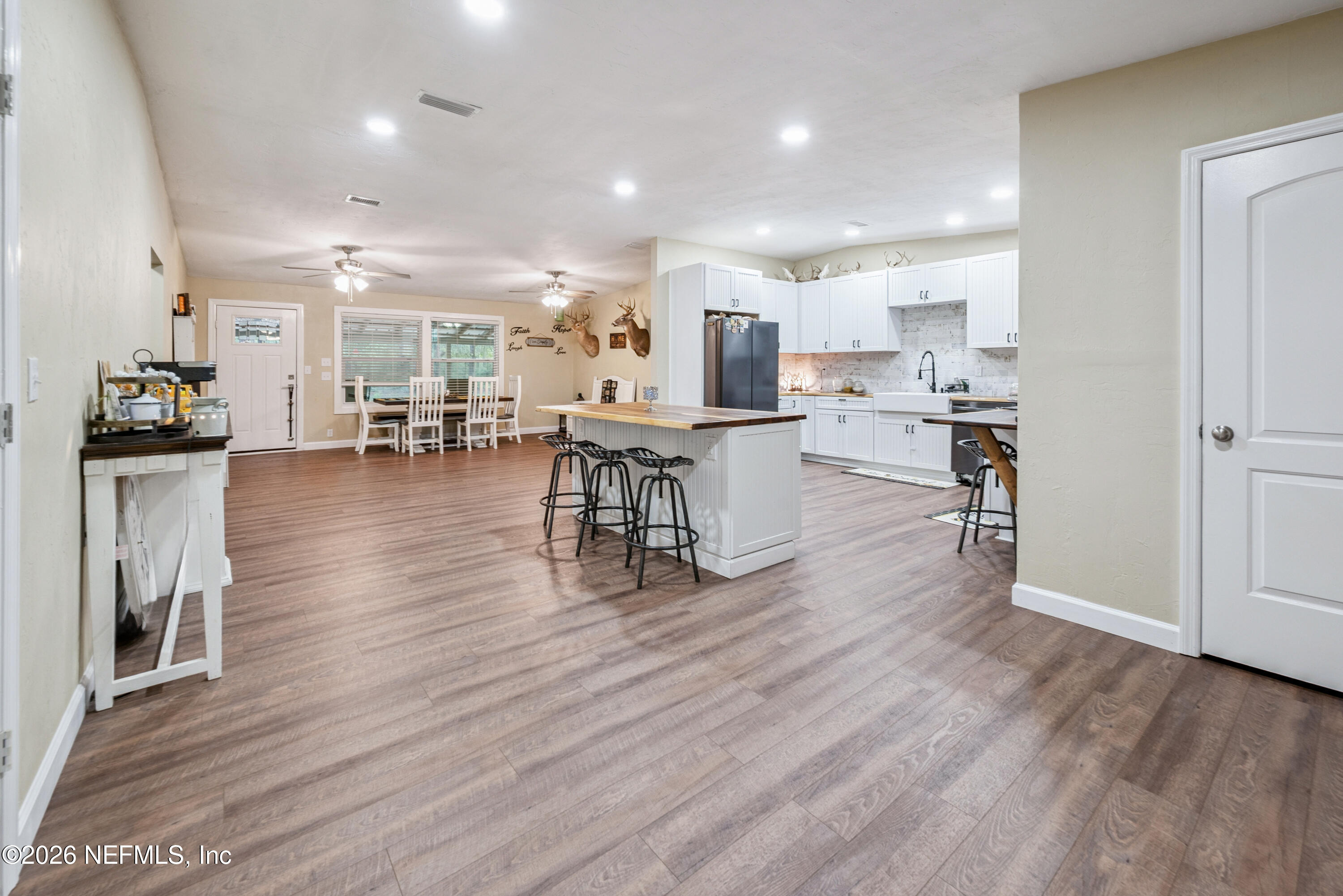 11309 Southwest 167th Circle Brooker, FL 32622 - Photo 13 of 42 a view of a dining room kitchen with furniture and wooden floor