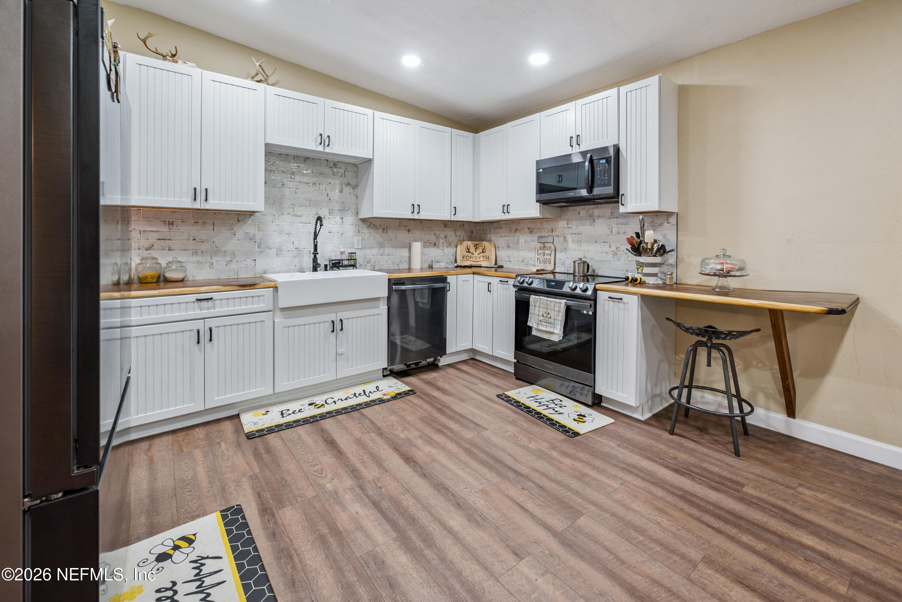 11309 Southwest 167th Circle Brooker, FL 32622 - Photo 18 of 42 a kitchen with a sink cabinets and wooden floor