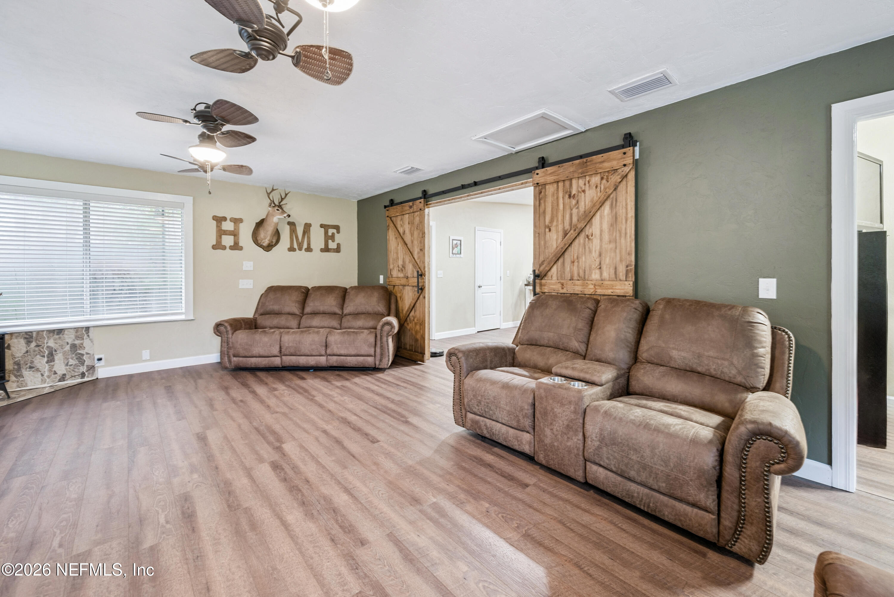 11309 Southwest 167th Circle Brooker, FL 32622 - Photo 21 of 42 a living room with furniture and a large window