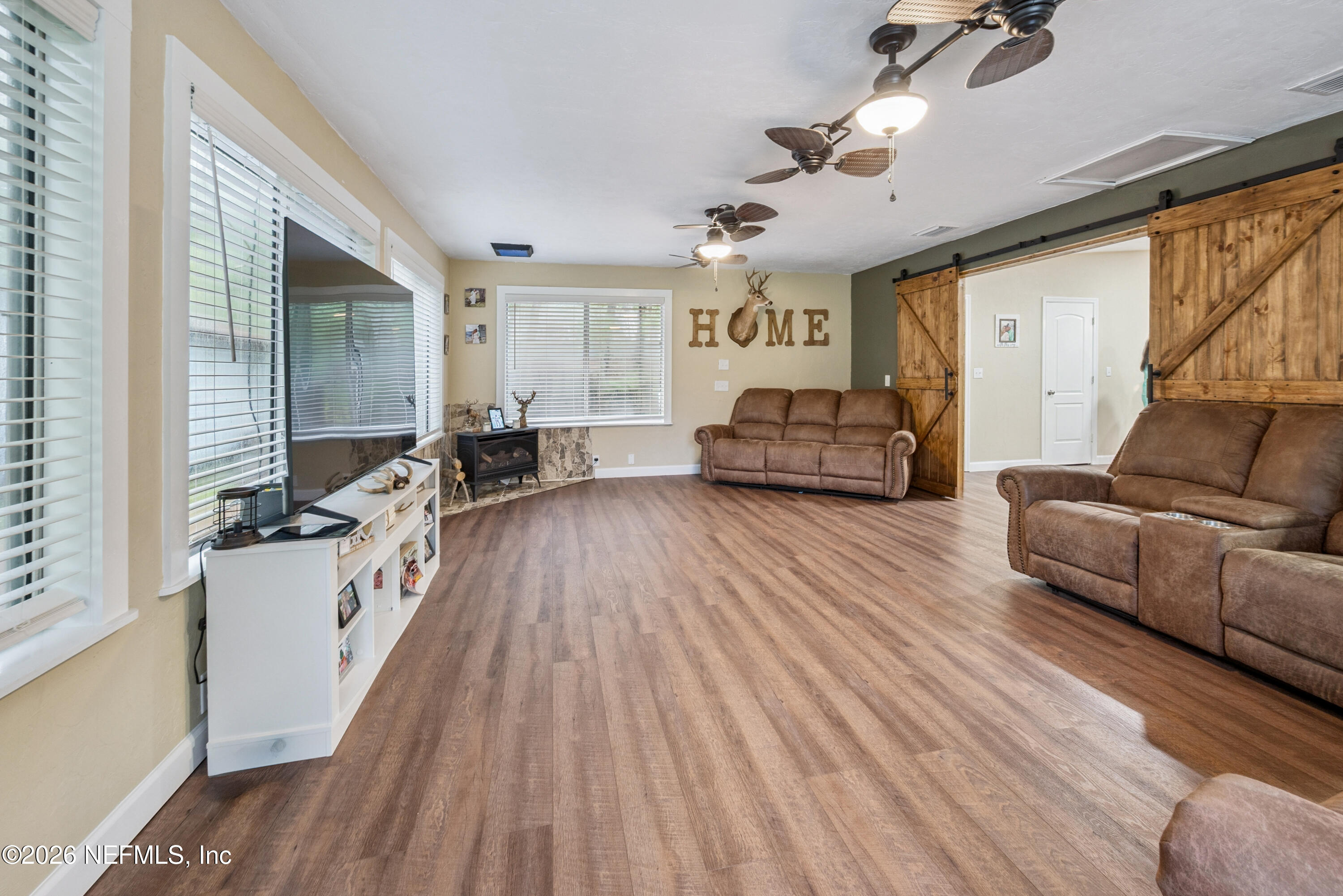 11309 Southwest 167th Circle Brooker, FL 32622 - Photo 22 of 42 a living room with furniture and a wooden floor