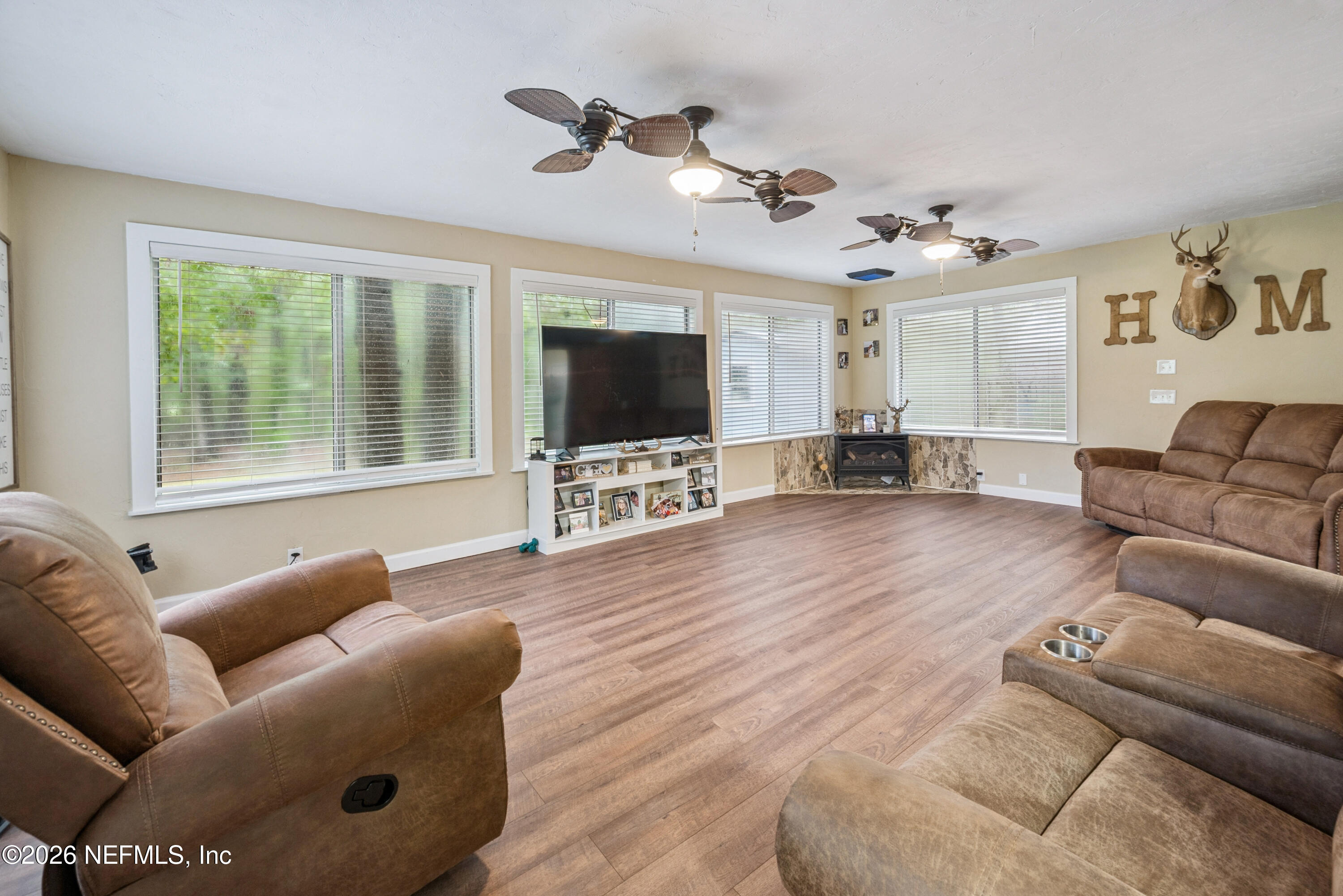 11309 Southwest 167th Circle Brooker, FL 32622 - Photo 23 of 42 a living room with furniture windows and a flat screen tv