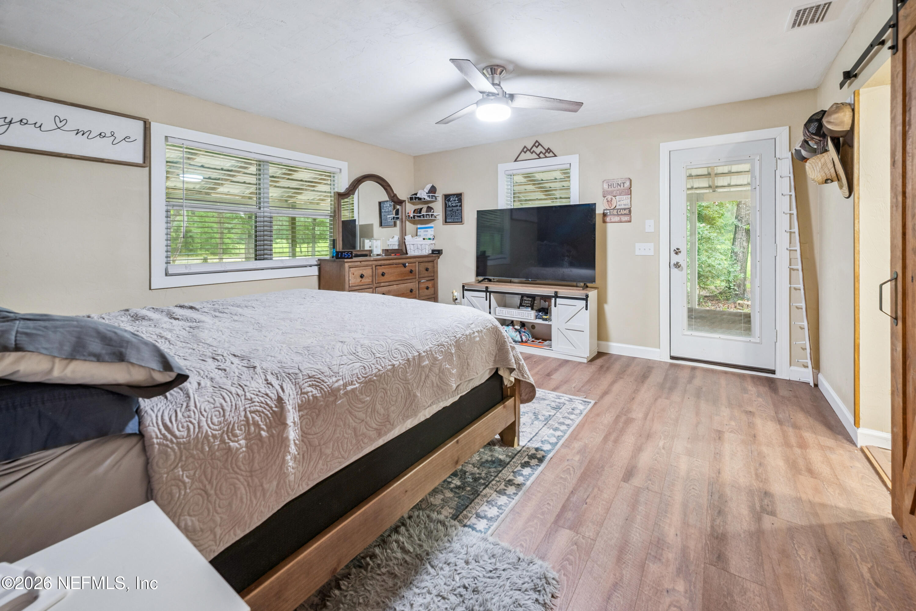 11309 Southwest 167th Circle Brooker, FL 32622 - Photo 26 of 42 a bedroom with a bed and a flat tv screen on dresser