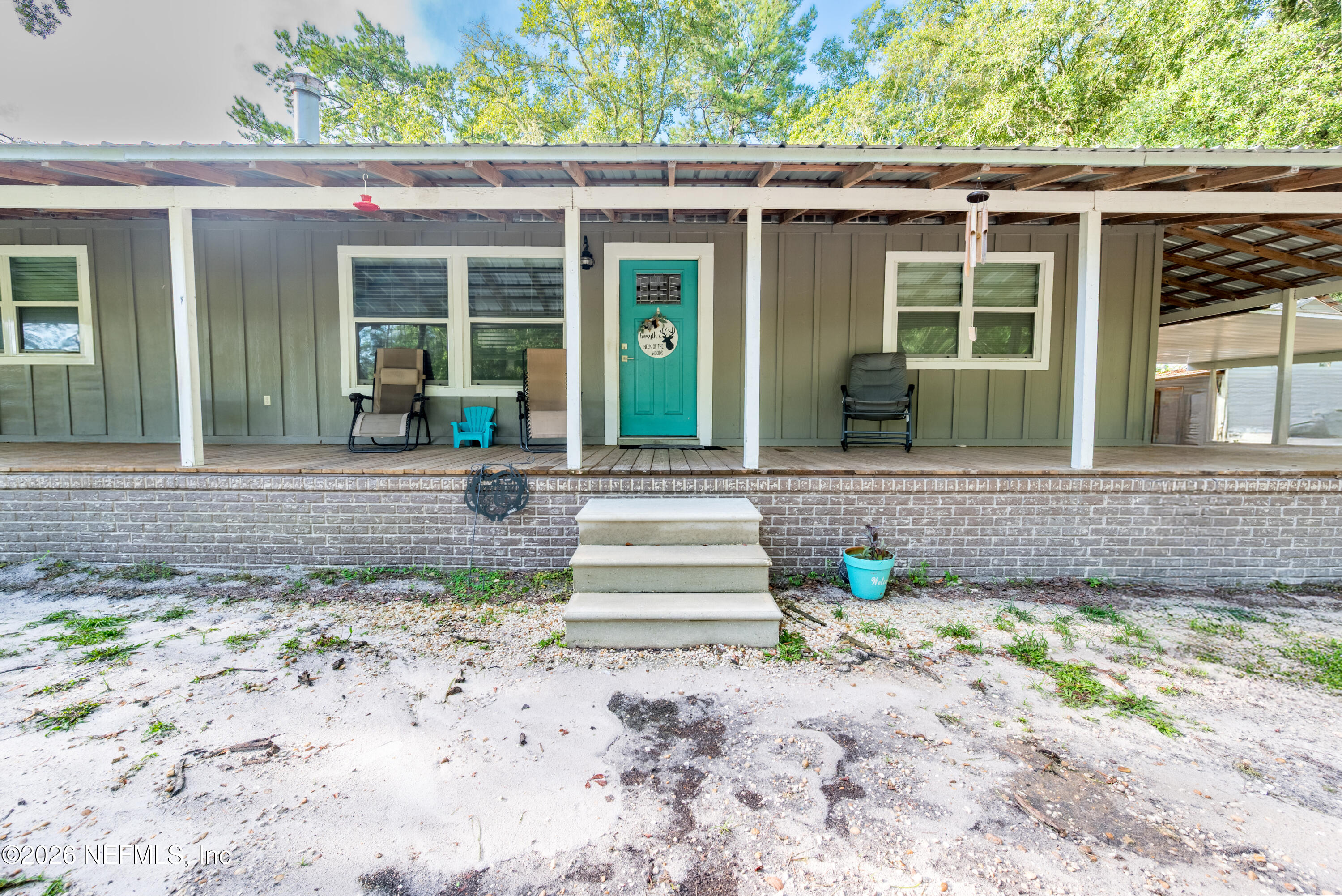11309 Southwest 167th Circle Brooker, FL 32622 - Photo 3 of 42 a front view of a house with garden and porch
