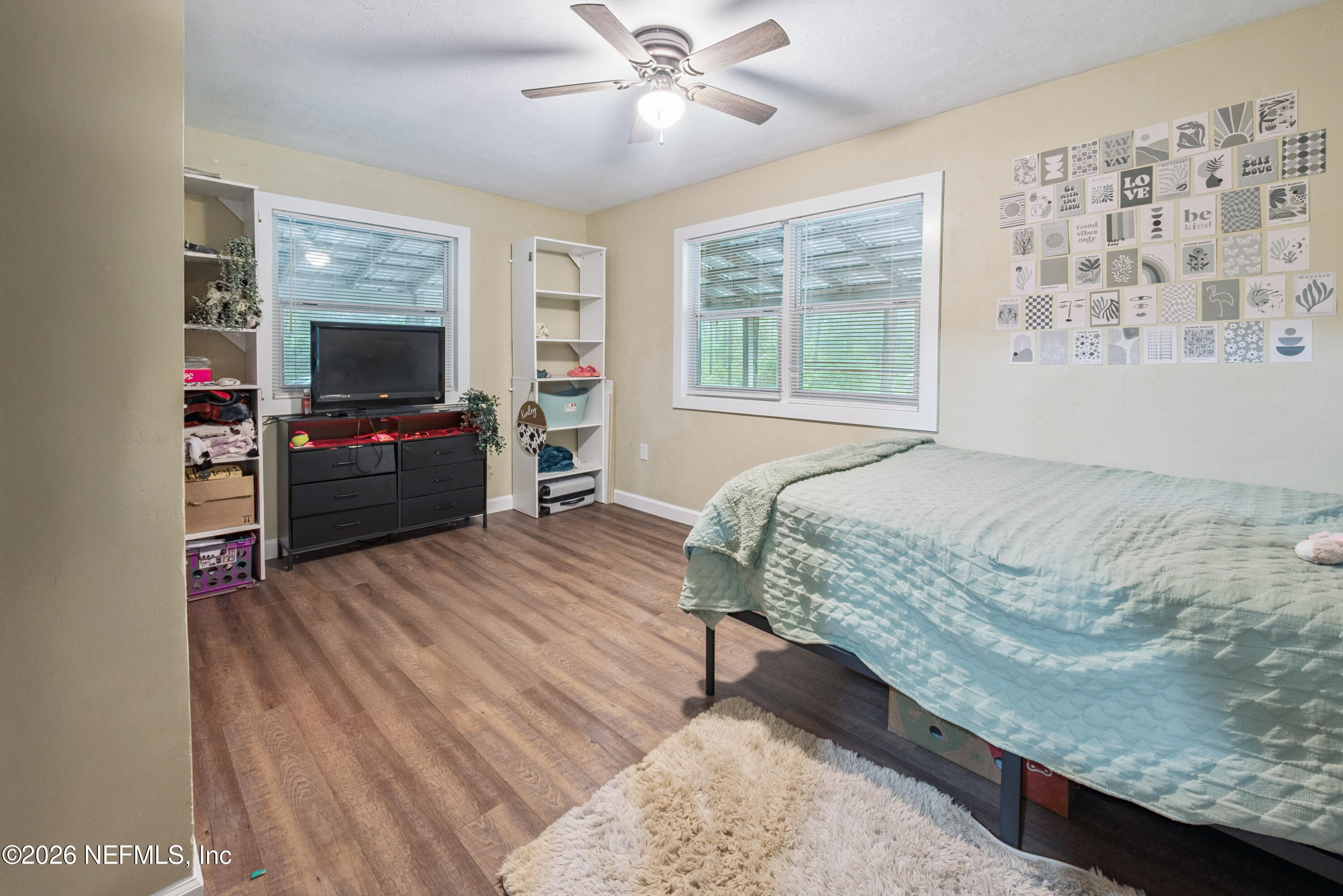 11309 Southwest 167th Circle Brooker, FL 32622 - Photo 32 of 42 a bedroom with a bed and a flat screen tv