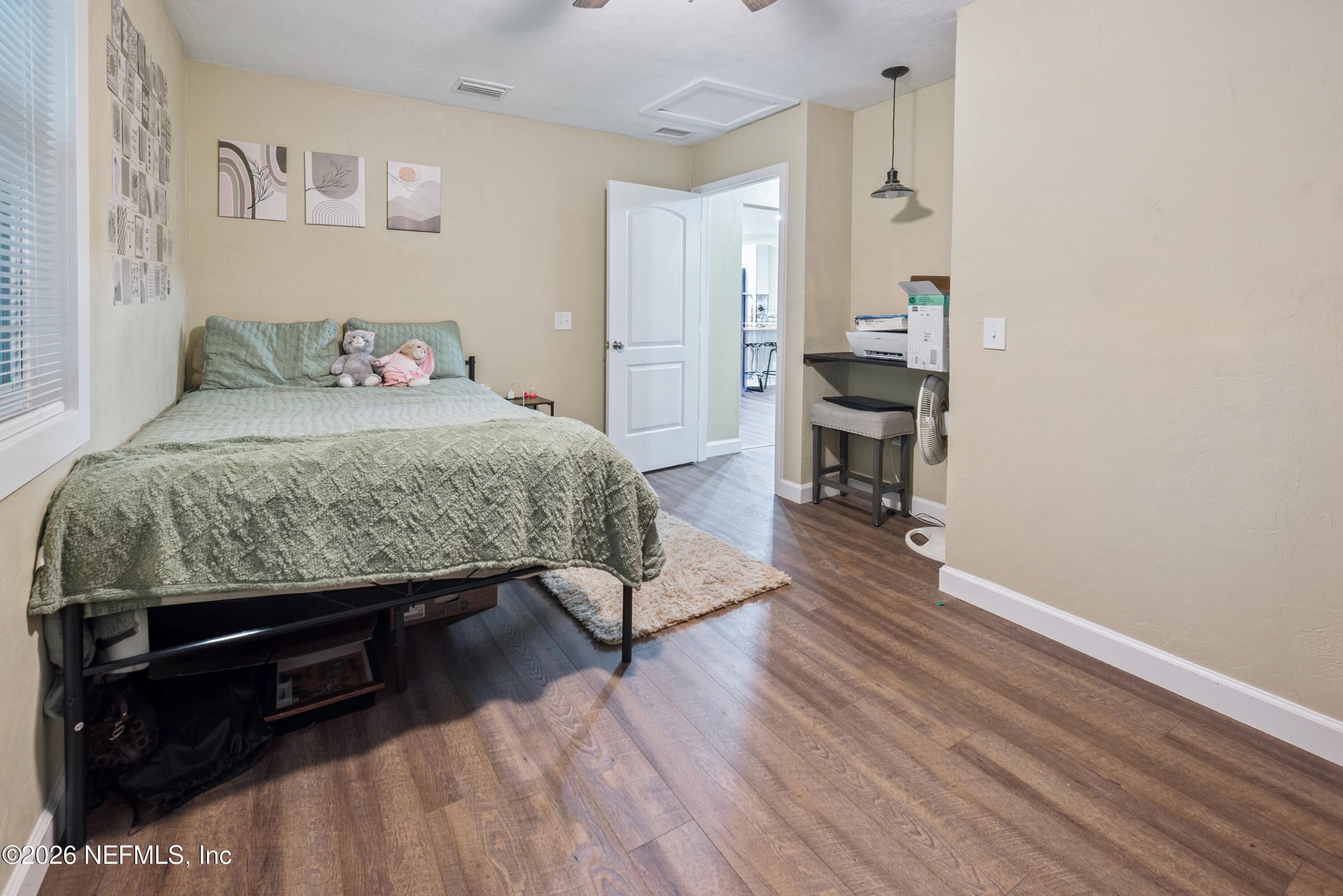 11309 Southwest 167th Circle Brooker, FL 32622 - Photo 34 of 42 a bedroom with a bed and wooden floor