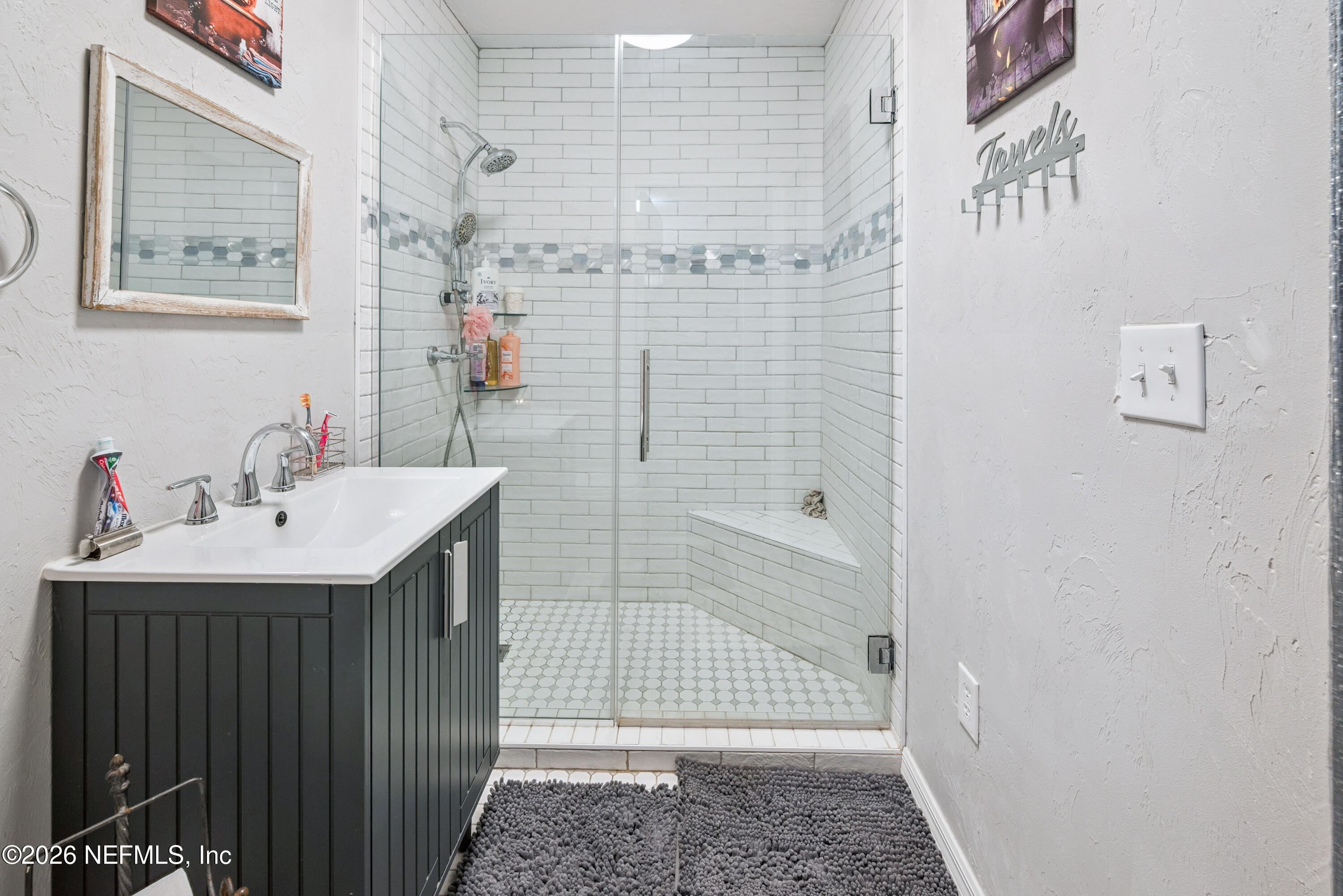 11309 Southwest 167th Circle Brooker, FL 32622 - Photo 39 of 42 a bathroom with a sink a mirror and shower