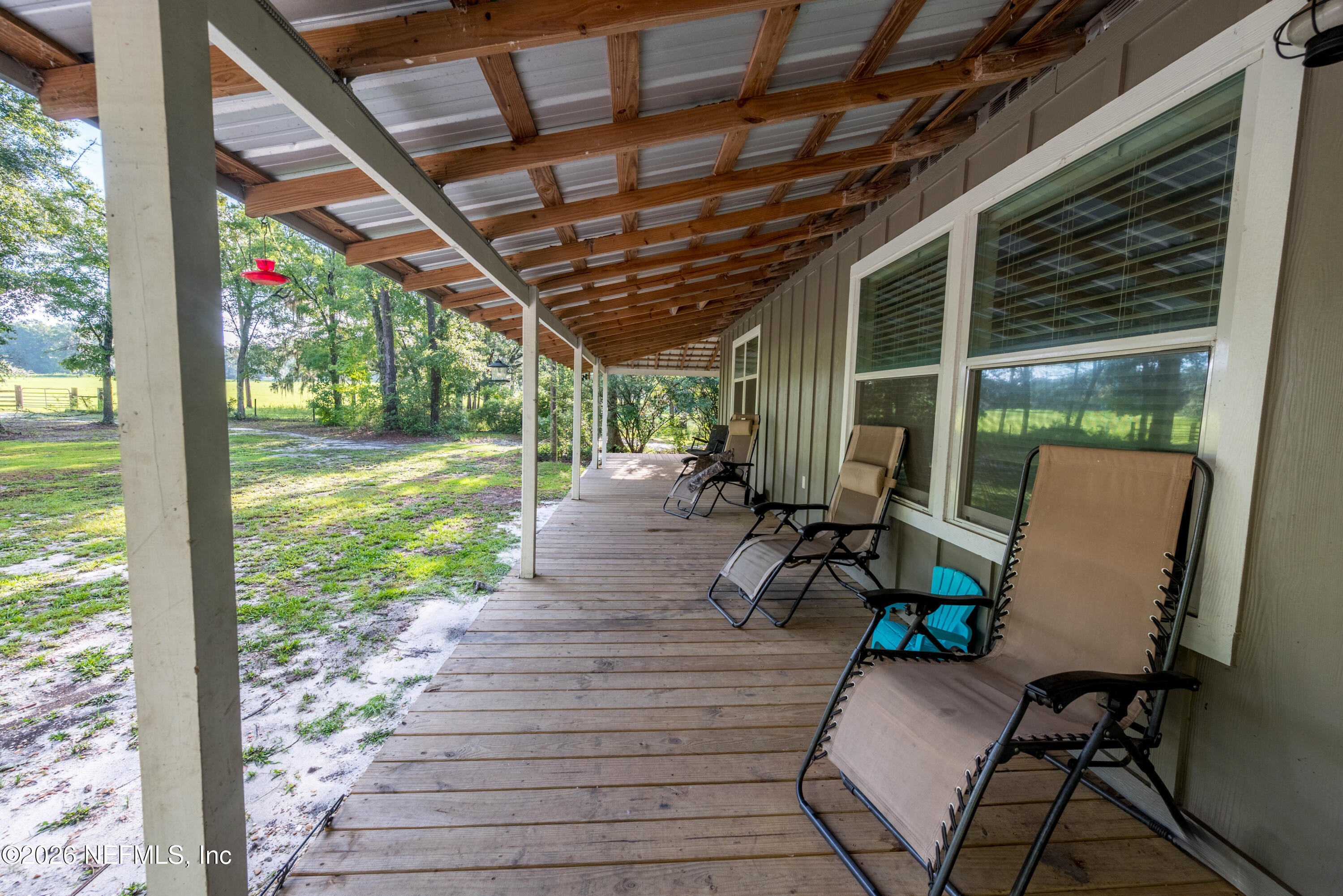 11309 Southwest 167th Circle Brooker, FL 32622 - Photo 9 of 42 a view of a porch with chairs and backyard