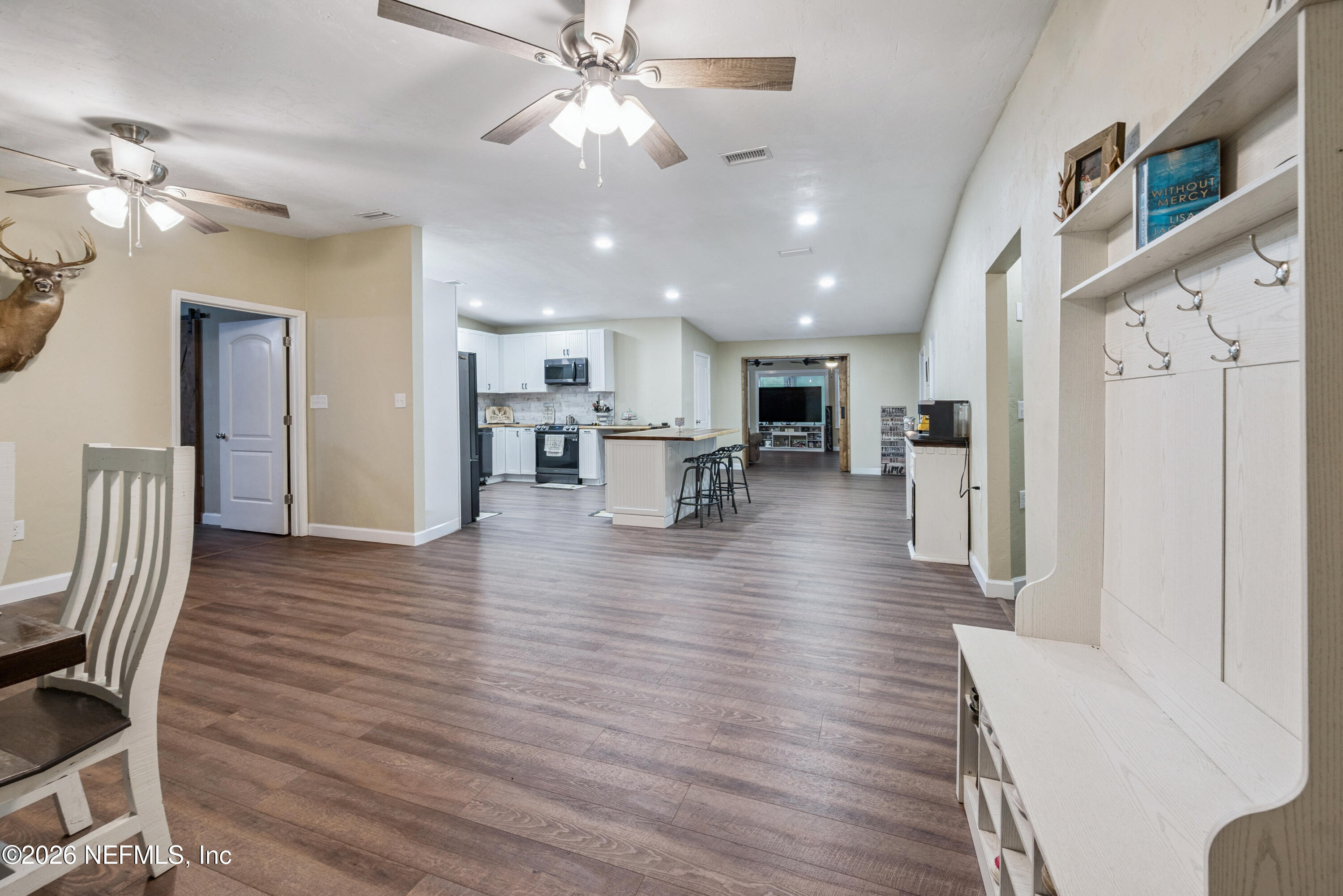 11309 Southwest 167th Circle Brooker, FL 32622 - Photo 10 of 42 a view of a dining room with furniture a chandelier and wooden floor