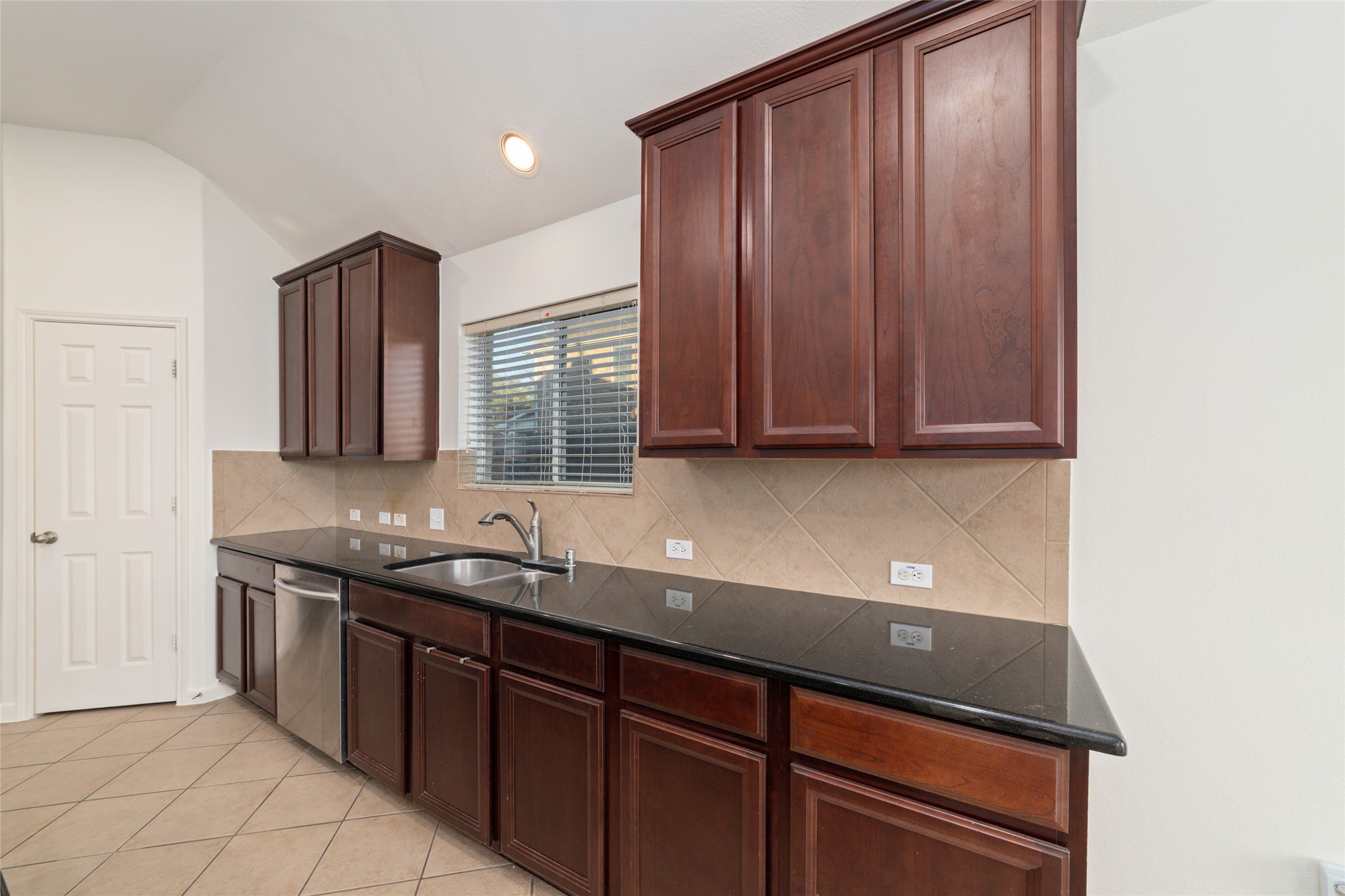12519 East Nantucket Road Sugar Land, TX 77478 - Photo 11 of 25 a kitchen with stainless steel appliances granite countertop wooden cabinets a sink and dishwasher