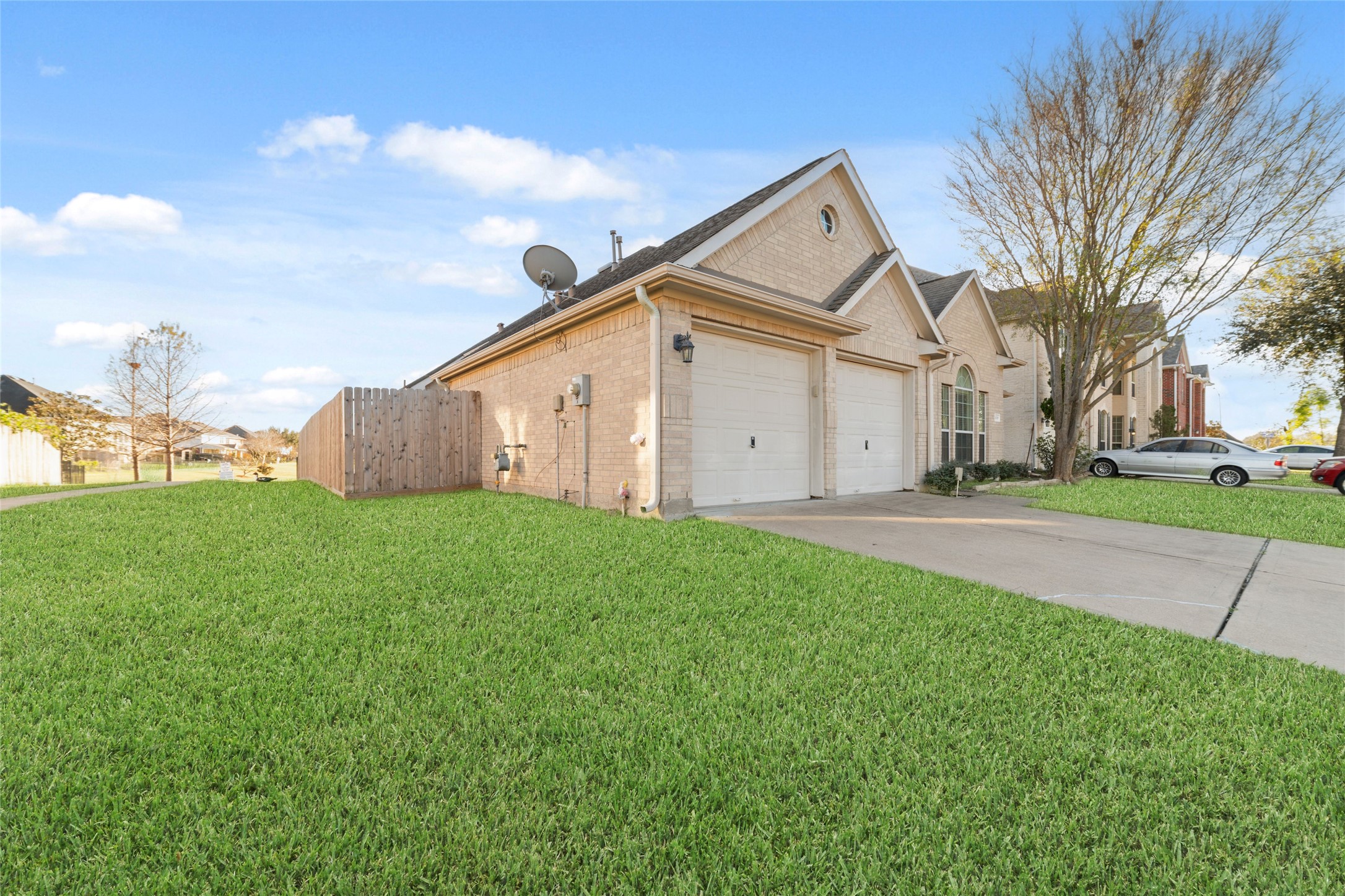 12519 East Nantucket Road Sugar Land, TX 77478 - Photo 2 of 25 a view of a white house with a big yard plants and large trees