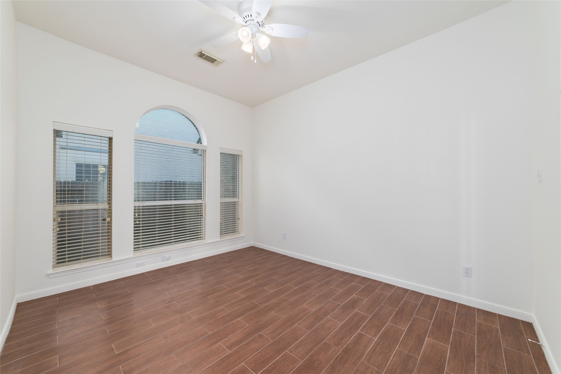 12519 East Nantucket Road Sugar Land, TX 77478 - Photo 21 of 25 a view of empty room with wooden floor and fan