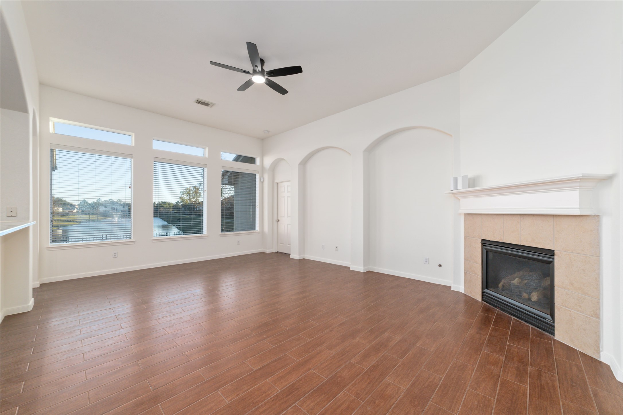 12519 East Nantucket Road Sugar Land, TX 77478 - Photo 7 of 25 a view of an empty room with a fireplace and a window