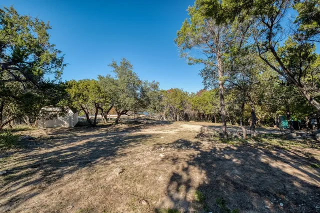 a view of dirt yard with a fountain