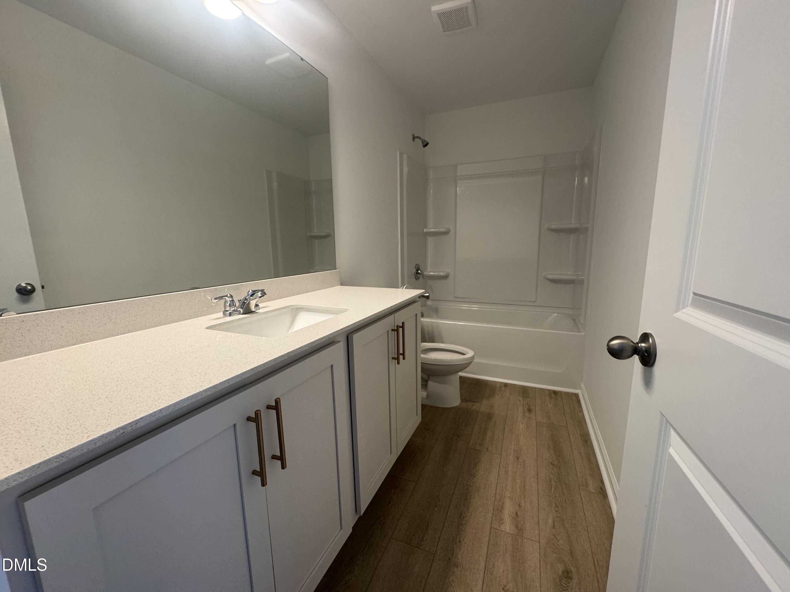 11742 Salers Loop Middlesex, NC 27557 - Photo 13 of 20 a bathroom with a double vanity sink toilet and shower