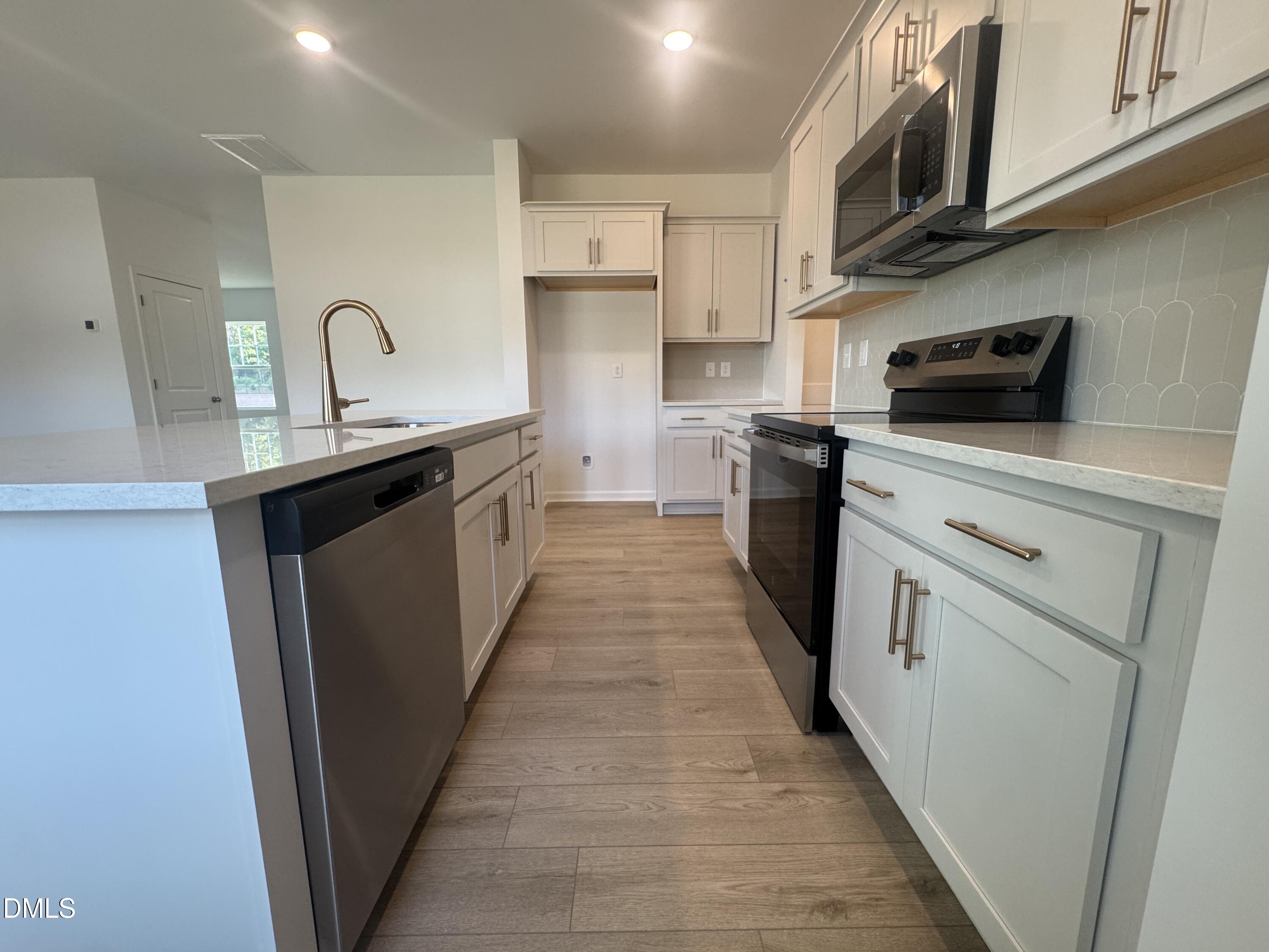 11742 Salers Loop Middlesex, NC 27557 - Photo 4 of 20 a kitchen with cabinets a sink and appliances