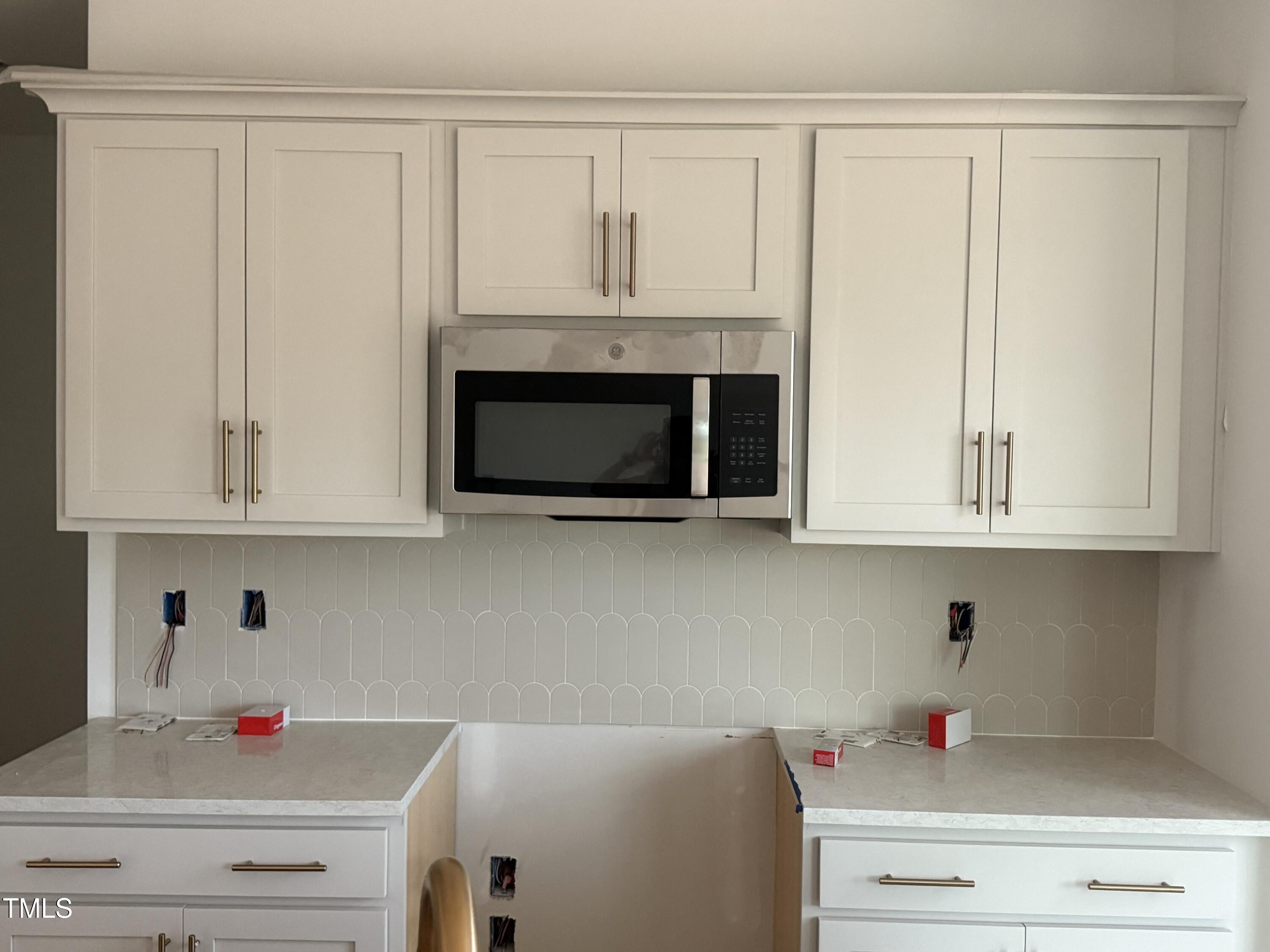 11742 Salers Loop Middlesex, NC 27557 - Photo 5 of 20 a kitchen with white cabinets and white appliances