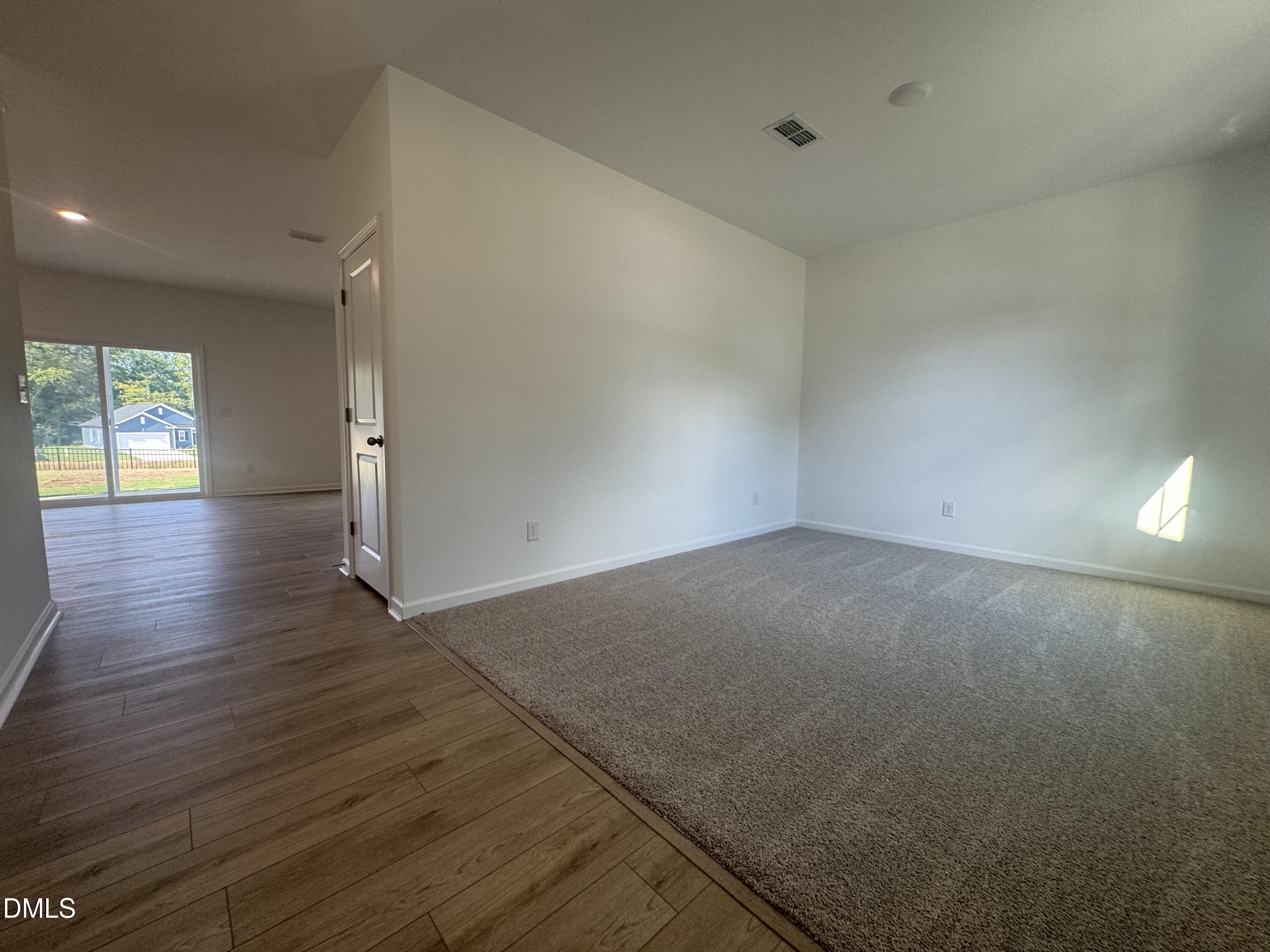 11742 Salers Loop Middlesex, NC 27557 - Photo 6 of 20 an empty room with wooden floor and windows