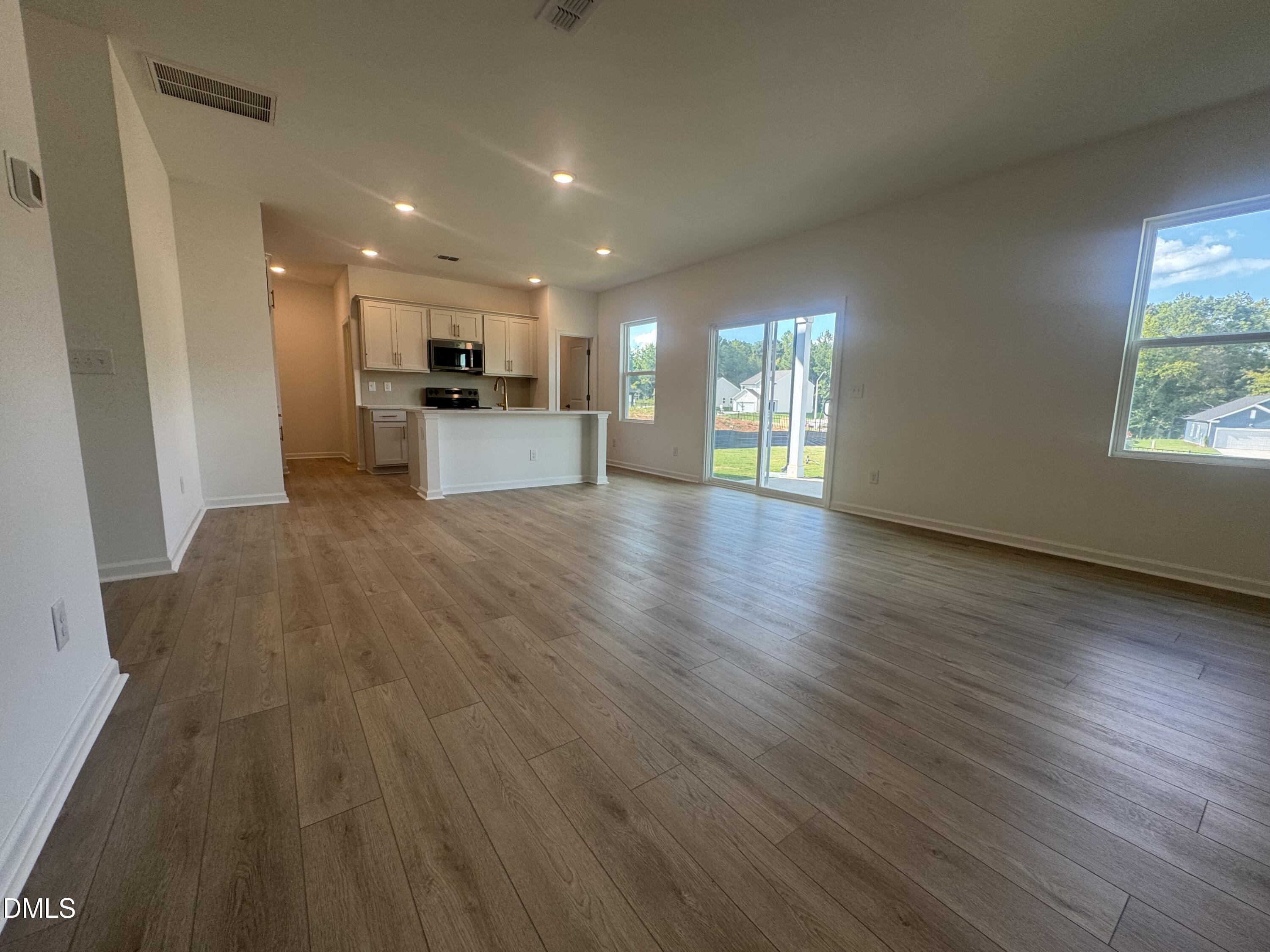 11742 Salers Loop Middlesex, NC 27557 - Photo 7 of 20 a view of an empty room with wooden floor and a window