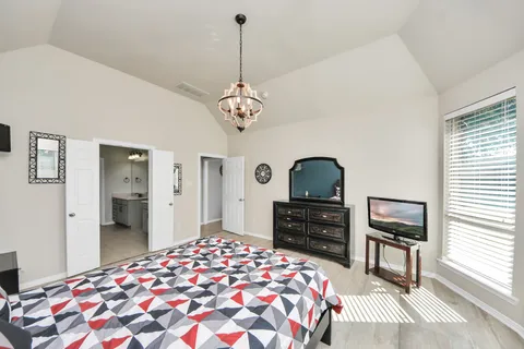 a bedroom with a bed and a dresser