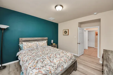 a bedroom with a bed and wooden floor