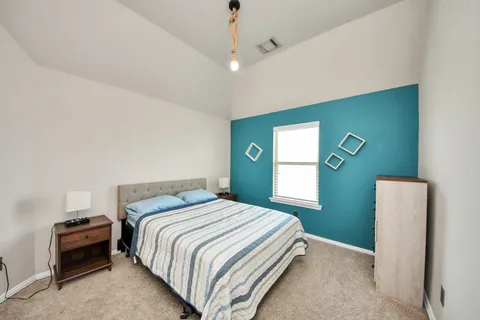 a bedroom with a bed and a mirror