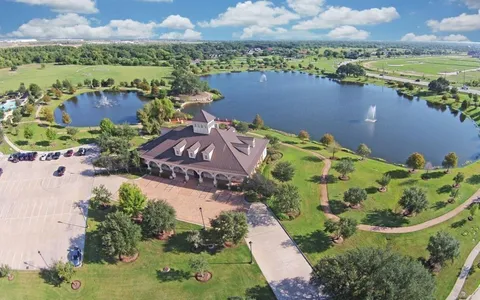 an aerial view of lake residential house with swimming pool and outdoor space