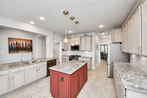 a kitchen with a sink stove and refrigerator