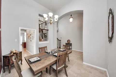 a view of a dining room with furniture and chandelier