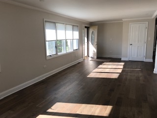 19506 West Manhattan Road Elwood, IL 60421 - Photo 3 of 32 an empty room with wooden floor and windows