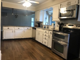 19506 West Manhattan Road Elwood, IL 60421 - Photo 9 of 32 a kitchen with cabinets stainless steel appliances and wooden floor
