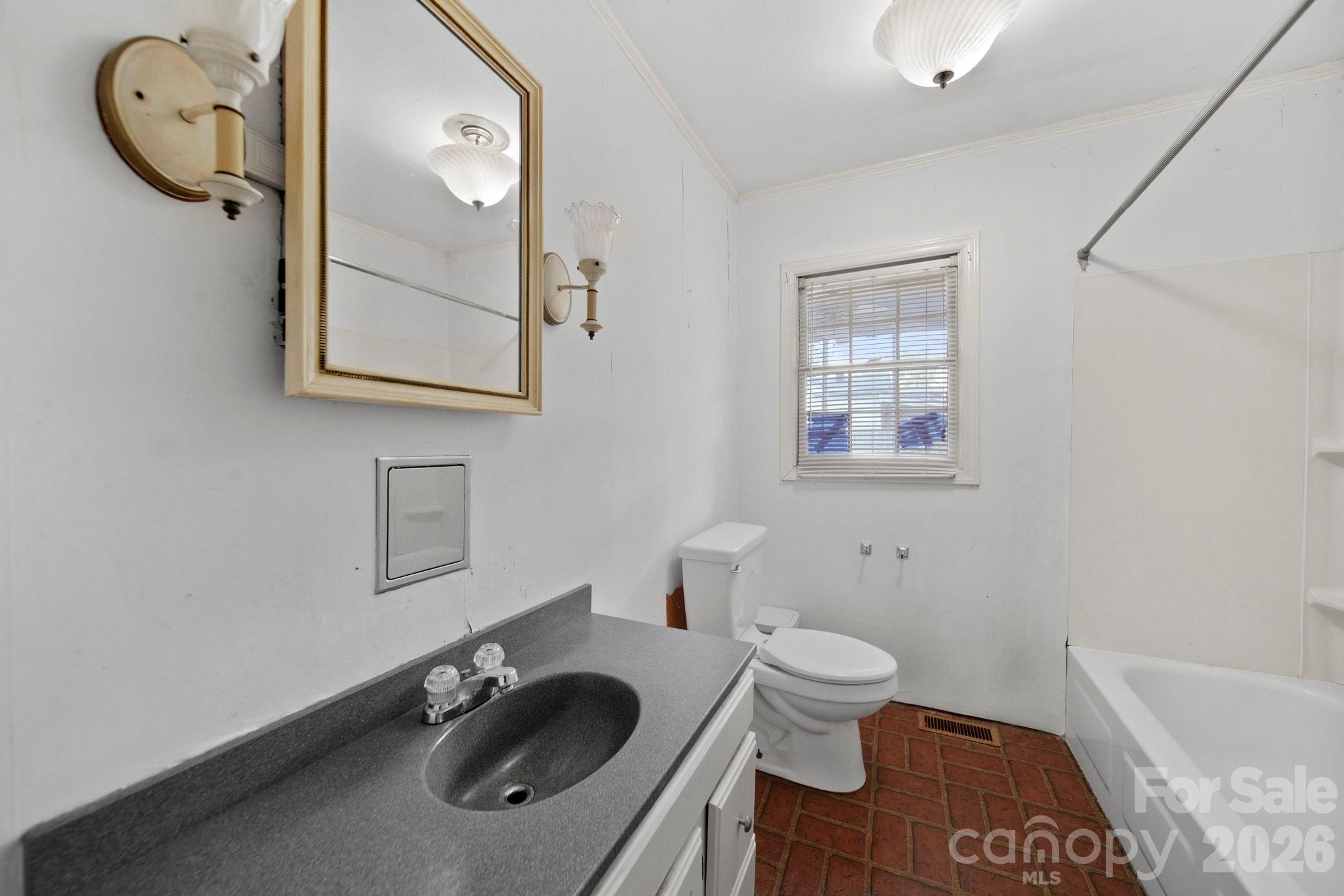 1109 Union Road Gastonia, NC 28054 - Photo 17 of 44 a bathroom with a granite countertop toilet sink and mirror