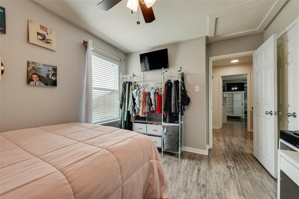 149 Cattlemans Creek Road Newark, TX 76071 - Photo 20 of 39 Bedroom with laminate floors, ceiling fan and lots of natural light at 149 Cattlemans Creek Rd in the Chisholm Springs neighborhood in Newark, TX 76071