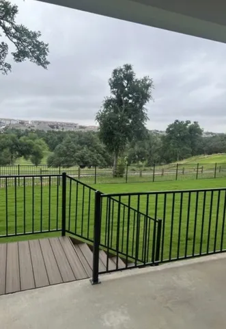 a view of a roof deck with a backyard