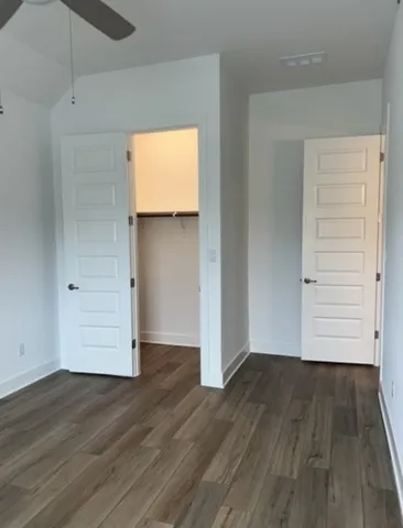 an empty room with wooden floor and closet