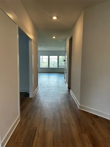 a view of hallway with wooden floor