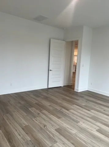 a view of an empty room and wooden floor