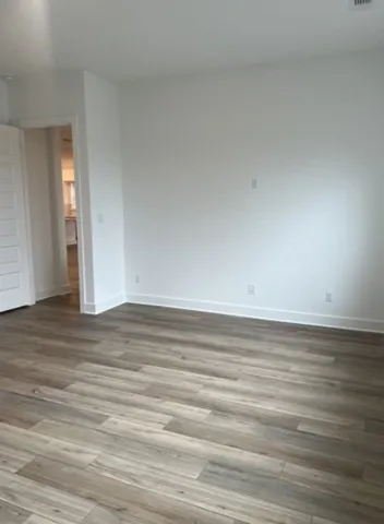 a view of an empty room and wooden floor