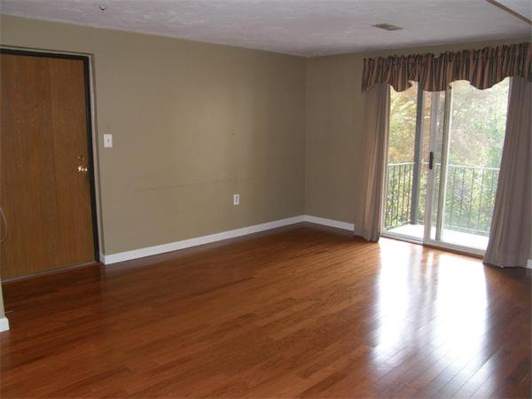 356 Neponset Street, Unit E Canton, MA 02021 - Photo 5 of 8 a view of an empty room with wooden floor and a window