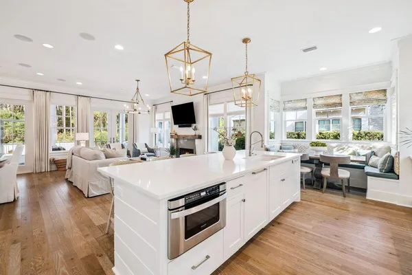 a dining room with furniture a chandelier and window