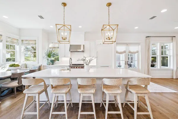 a kitchen with stainless steel appliances a white stove and cabinets
