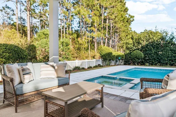 a swimming pool with trees in the background
