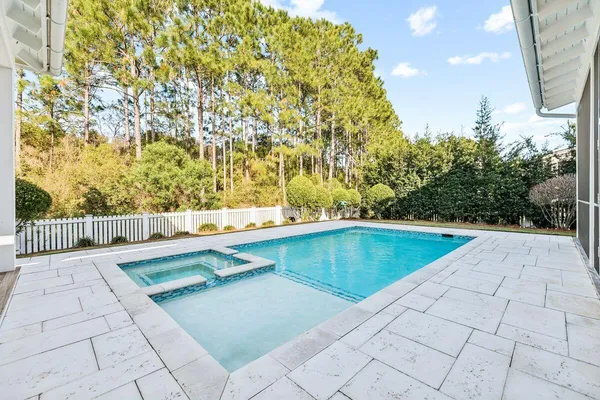 a view of a swimming pool with a chair and tables